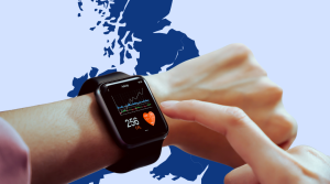 A person checks their health statistics on a smart watch against a blue background of the united kingdom.