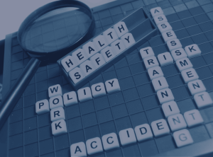 Scrabble tiles spelling out words relating to occupational health: training, work, policy, accident.